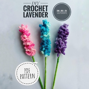May include: Three handmade crochet lavender stems in pink, blue, and purple. The stems have green stalks and are arranged against a white background. Text at the top reads "DIY CROCHET LAVENDER" and a speech bubble says "PDF PATTERN".
