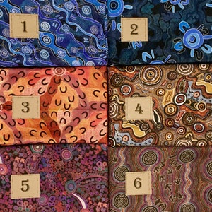 May include: Six different fabric swatches featuring Aboriginal art designs. The swatches are numbered 1 to 6. The designs feature a variety of colours, including blue, red, orange, brown, and black.