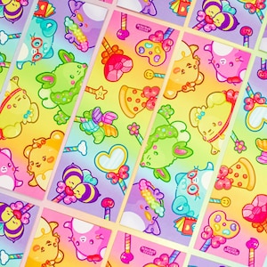 May include: A set of colourful stickers featuring cute cartoon characters, candy, and rainbows. The stickers are printed on glossy paper and have a holographic finish.