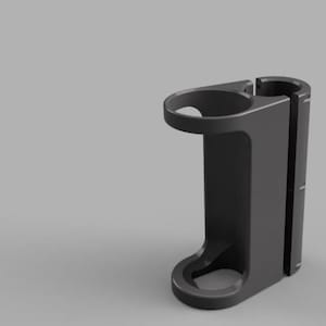 May include: A dark grey, 3D-rendered holder with a circular top and bottom opening, and a side opening. The holder has a curved handle-like extension on the side. The design is modern and minimalist.