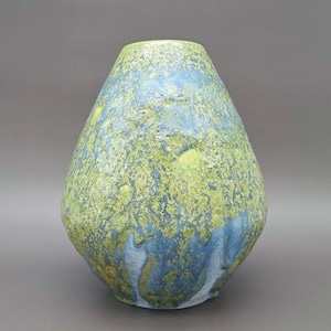 May include: A handcrafted ceramic vase with a textured surface. The vase features a teardrop shape with a wide base and a narrow opening. The color palette includes shades of blue, green, and yellow, creating a unique and artistic appearance.