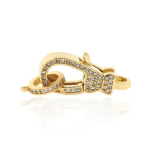 May include: Gold-toned clasp with clear crystal embellishments. The clasp is designed to be used for necklaces or bracelets.