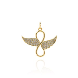 May include: Gold pendant necklace with a infinity symbol design with wings. The wings are covered in small clear stones.