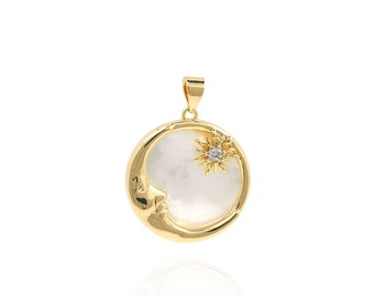 May include: Gold pendant necklace featuring a crescent moon design with a white mother-of-pearl inlay and a small sun with a clear crystal in the center.