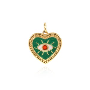 May include: A gold-colored heart-shaped pendant with a green enamel background. The pendant features a white eye with a red center. The heart is outlined with a gold beaded border and has a small loop for a chain.