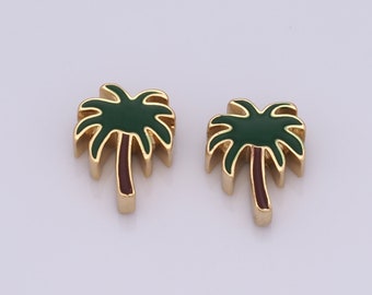 Puede incluir: Dos abalorios de palmera de oro con hojas verdes y troncos marrones.