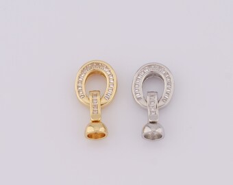May include: Two gold and silver tone metal clasps with clear crystal accents. The clasps are round with a small ball at the bottom.