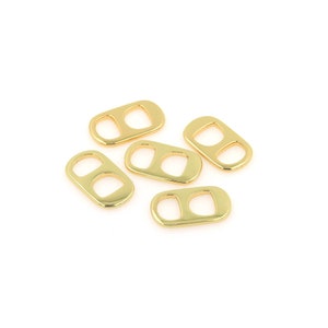 May include: Five gold-coloured metal pull tabs, also known as ring pulls, for beverage cans. These tabs are commonly used in crafting and jewellery making.