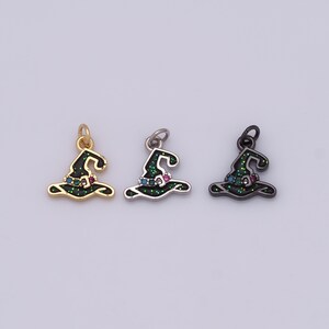 May include: Three witch hat charms in gold, silver, and black. Each charm features a green glitter design with colorful gemstones. The charms are small, with a loop at the top for attaching to jewelry or other crafts.