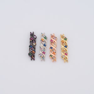 May include: Four colorful chain connectors with rainbow colored cubic zirconia stones. The connectors are in black, silver, rose gold, and gold finishes.