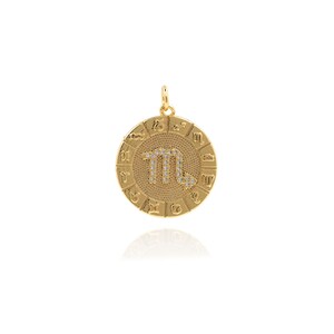 May include: Gold zodiac pendant featuring the Scorpio constellation with sparkling rhinestones. The pendant is surrounded by a circle of zodiac signs.