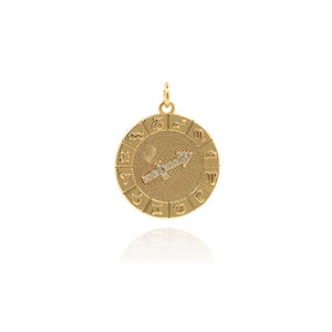May include: Gold zodiac pendant featuring the Sagittarius constellation with clear crystals. The pendant is round and has all 12 zodiac signs around the edge.