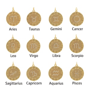 May include: Twelve gold zodiac pendants with white crystal accents. Each pendant features a different zodiac symbol.