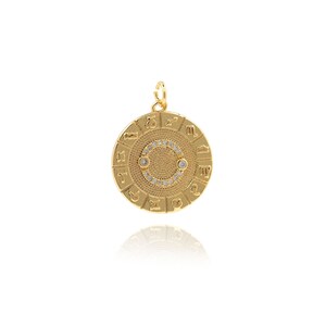 May include: Gold-toned zodiac pendant with a circle of clear rhinestones around the edge. The pendant features the twelve zodiac signs in a circle around the edge.