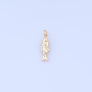 May include: A gold-coloured fish charm with detailed scales and fins. The charm has a small loop at the top for attaching to a necklace or bracelet. The fish is a classic nautical design.
