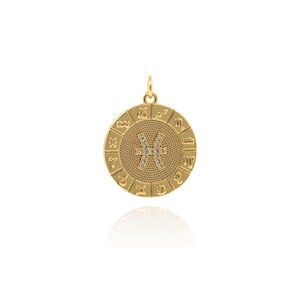 May include: Gold zodiac pendant with a circle of zodiac signs and a Pisces symbol in the center, set with clear crystals.
