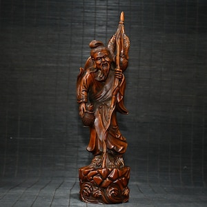 Wood carving of boxwood/hand-carved fisherman statue.nn