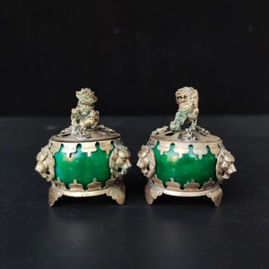 May include: Two antique silver and green jade incense burners with lion head handles and a lion finial on top.