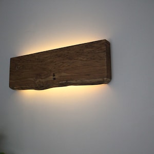 Wall lamp made from old rustic oak. Indirect LED lightning, dimmable with remote control.