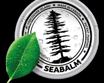 May include: A silver round container with a black and white image of a tree and the text "Original Seabalm", "Vancouver Island", "Made in Canada", and "Patent Pending". A green leaf with water droplets is in the foreground.