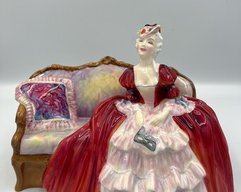 A stunning and highly collectible vintage figurine by Royal Doulton titled “Belle O’ The Ball” (HN1997), originally produced in 1946.