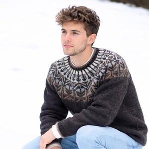 May include: A set of three ceramic mugs with a speckled, matte finish. The mugs are in shades of cream, light grey, and dark grey. Each mug has a simple, minimalist design, ideal for coffee or tea.