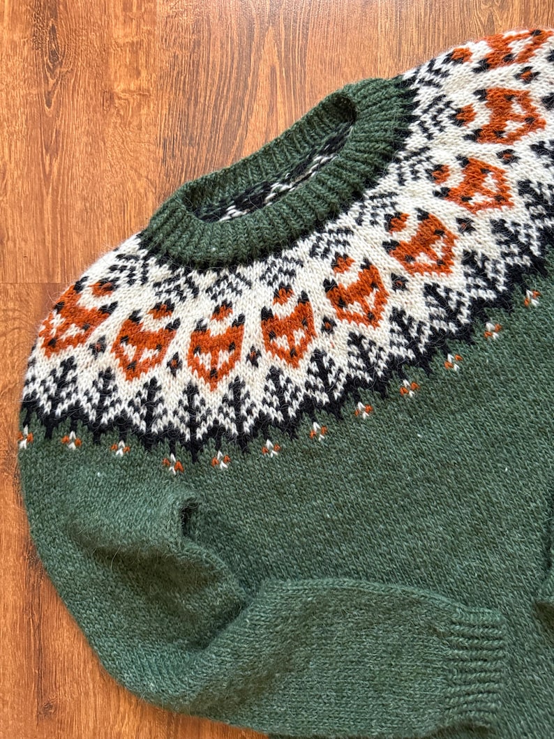 Close up: Lyme Grass Green Hand-knitted Icelandic wool Into the Wild sweater with a fox yoke pattern, made from genuine Icelandic wool by Knitting.Tallinn.