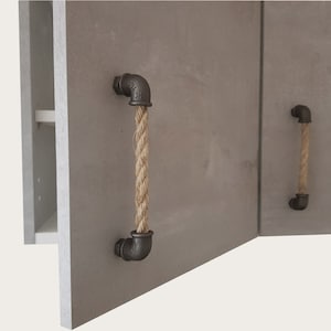 May include: Two cabinet doors with industrial style rope handles. The handles are made of black metal pipes with a natural rope wrapped around them.