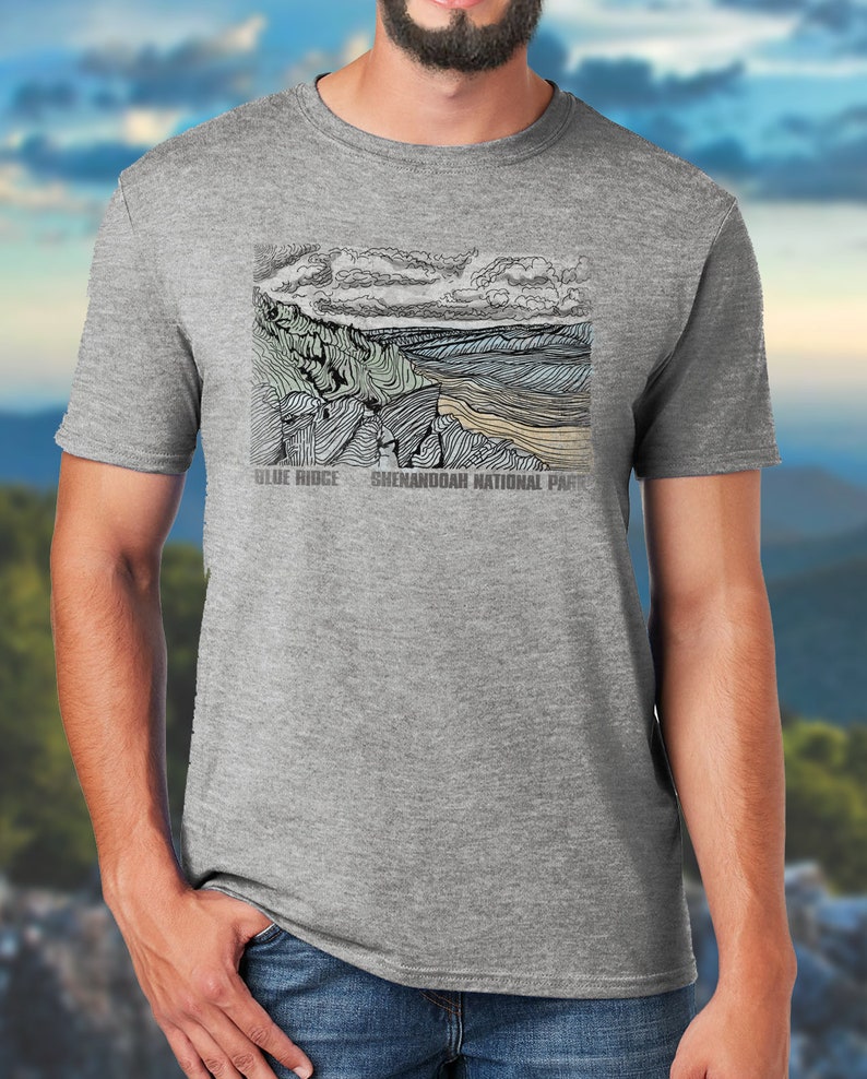 May include: A heather grey t-shirt with a black and white line drawing of a mountain range and the text "Blue Ridge Shenandoah National Park".