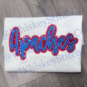 May include: White t-shirt with a red and blue sequined "Apaches" design.