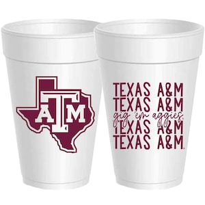 May include: Two white foam cups with a Texas A&M logo. One cup features a maroon outline of the state of Texas with the letters "A&M" inside. The other cup has the words "Texas A&M" repeated four times, with the phrase "gig 'em aggies" in between the second and third lines.