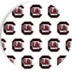 May include: A white circular design featuring a repeating pattern of the letter "C" in black, each containing a red Gamecock mascot. The design is a collegiate sports theme.