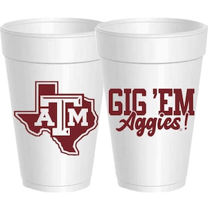 May include: Two white foam cups with maroon logos. One cup features the Texas state outline with the letters "A" and "M" inside. The other cup says "Gig 'Em Aggies!"