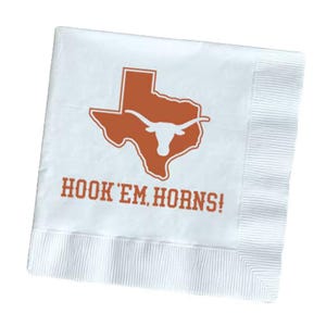 May include: White paper napkin with an orange outline of the state of Texas and a longhorn logo. The phrase "HOOK 'EM HORNS!" is printed in orange below the logo. The napkin has a ribbed border.