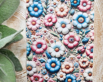 May include: A floral pattern with pink, blue, and white flowers on a beige background. The flowers are stylized and have a 3D effect.