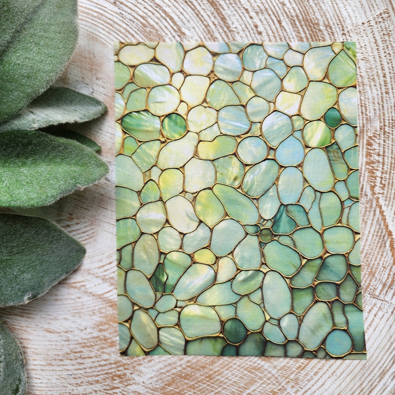 May include: A green and gold abstract pattern with a mosaic of rounded shapes. The pattern is reminiscent of a stone or tile design.