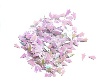 Puede incluir: Un montón de purpurina iridiscente rosa y blanca con forma de árboles de Navidad.