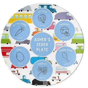 May include: A blue and white Passover Seder plate with a car theme. The plate features illustrations of the six Seder plate items: lettuce, bitter herbs, charoset, shank bone, egg, and parsley. The plate also includes the text "Asher's Seder Plate" in the center.