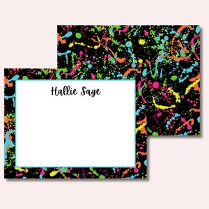 May include: A black and white card with a neon paint splatter design. The card has a white space in the center with the text "Hallie Sage" written in black.