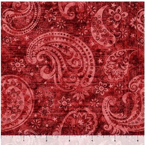 May include: A close-up of a red paisley fabric with a distressed texture. The fabric features large paisley patterns, floral accents, and star shapes in a lighter shade of red. The pattern repeats across the fabric.