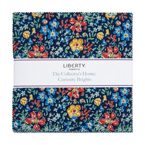 May include: A pack of fabric squares featuring a floral print in shades of blue, red, yellow, and green on a dark blue background. The fabric is labeled "Liberty Fabrics The Collector's Home: Curiosity Brights."