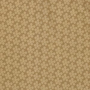 May include: Close-up of a tan fabric with a repeating pattern of small, off-white floral clusters. The flowers are densely packed, creating a textured appearance. The background is a solid, warm tan color.