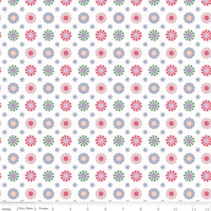 May include: A white fabric featuring a repeating pattern of multi-colored flowers in shades of pink, purple, teal, and peach, with smaller light blue flowers in between. A ruler at the bottom shows a scale of 12 inches for the fabric width.