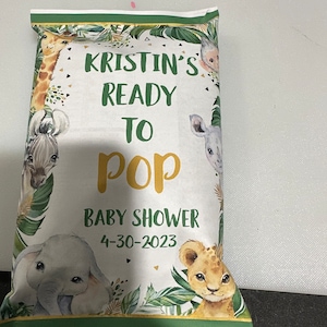 May include: A white and green baby shower favor bag with a jungle animal theme. The bag has the text "Kristin's Ready to Pop Baby Shower 4-30-2023" printed on it.