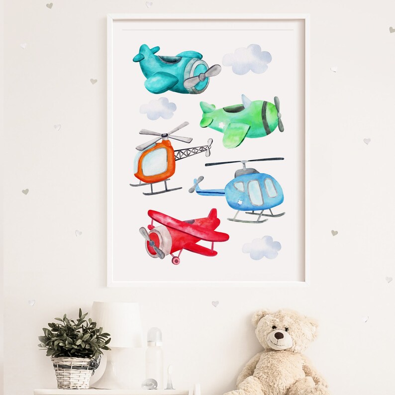 May include: Watercolor print of various aircraft, including airplanes and helicopters, in shades of blue, green, red, and orange. The artwork features fluffy white clouds and is framed in a white border.