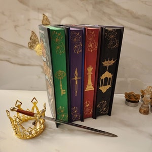 The inheritance Games, The Hawthorn Legacy, and The Final Gambit with stenciled edges