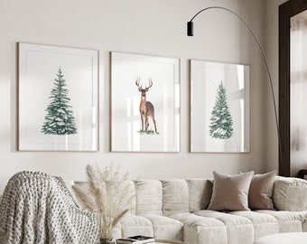 May include: Three framed watercolor illustrations of winter scenes. The first illustration shows a green pine tree with snow on the branches. The second illustration shows a brown deer standing in a snowy forest. The third illustration shows a green pine tree with snow on the branches.