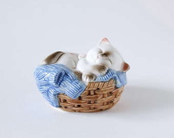 sleeping cat in basket toy