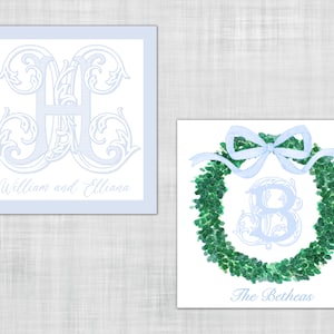 May include: Two square cards with light blue and white designs. One features a monogram with the names "William and Elliana." The other shows a green wreath with a light blue bow and monogram, with the text "The Betheas."