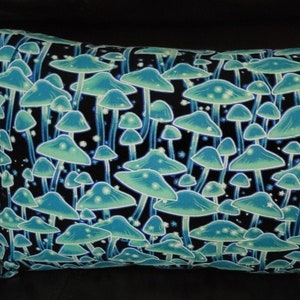 May include: A decorative pillow with a black background and a pattern of glowing blue mushrooms.